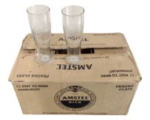 A box of twenty four Amstel branded pint glasses