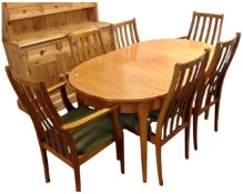 A 20th century Stateroom oval teak extending dining table together with six rail back chairs,