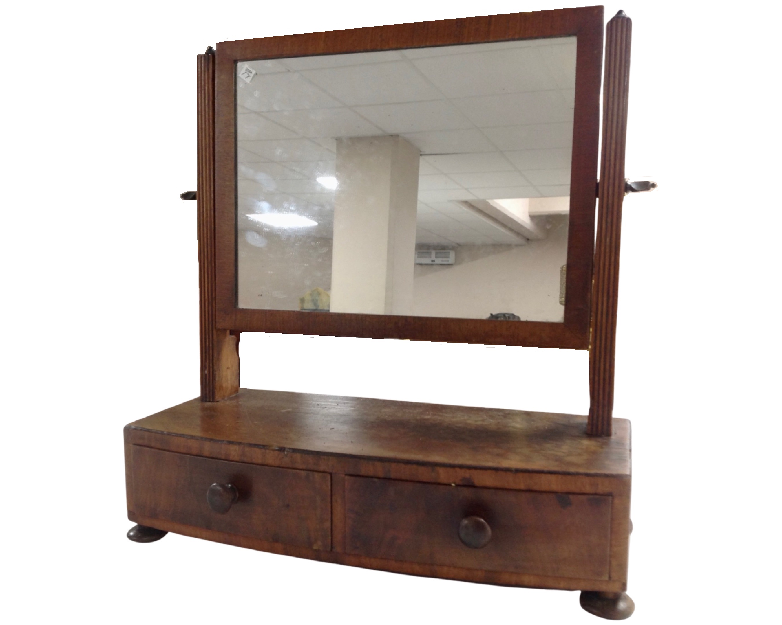A George III mahogany toilet mirror fitted with two drawers.
