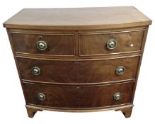 A mahogany bow fronted two-over-two four drawer chest.