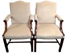 A pair of George III style mahogany armchairs upholstered in a dralon fabric.