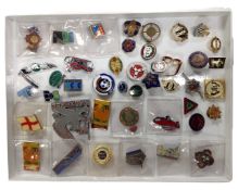 A collection of assorted enamel pin badges.