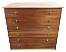 A mid-20th century stained plywood six drawer chest.