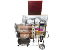 A contemporary metal and glass three tier trolley together with two further metal wine racks,