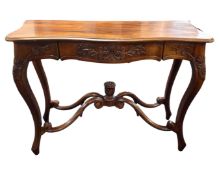 An Indonesian hardwood carved serpentine front hall table, 106cm wide by 40cm deep by 80cm high.