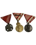 An Austrian Military Merit medal in gilt, together with two further Austrian WWI era medals.