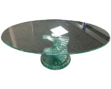 A contemporary all glass oval occasional table on twist support