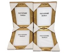 Six gilt photo frames, 30cm by 40cm.