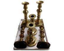 Three pairs of antique brass candlesticks.