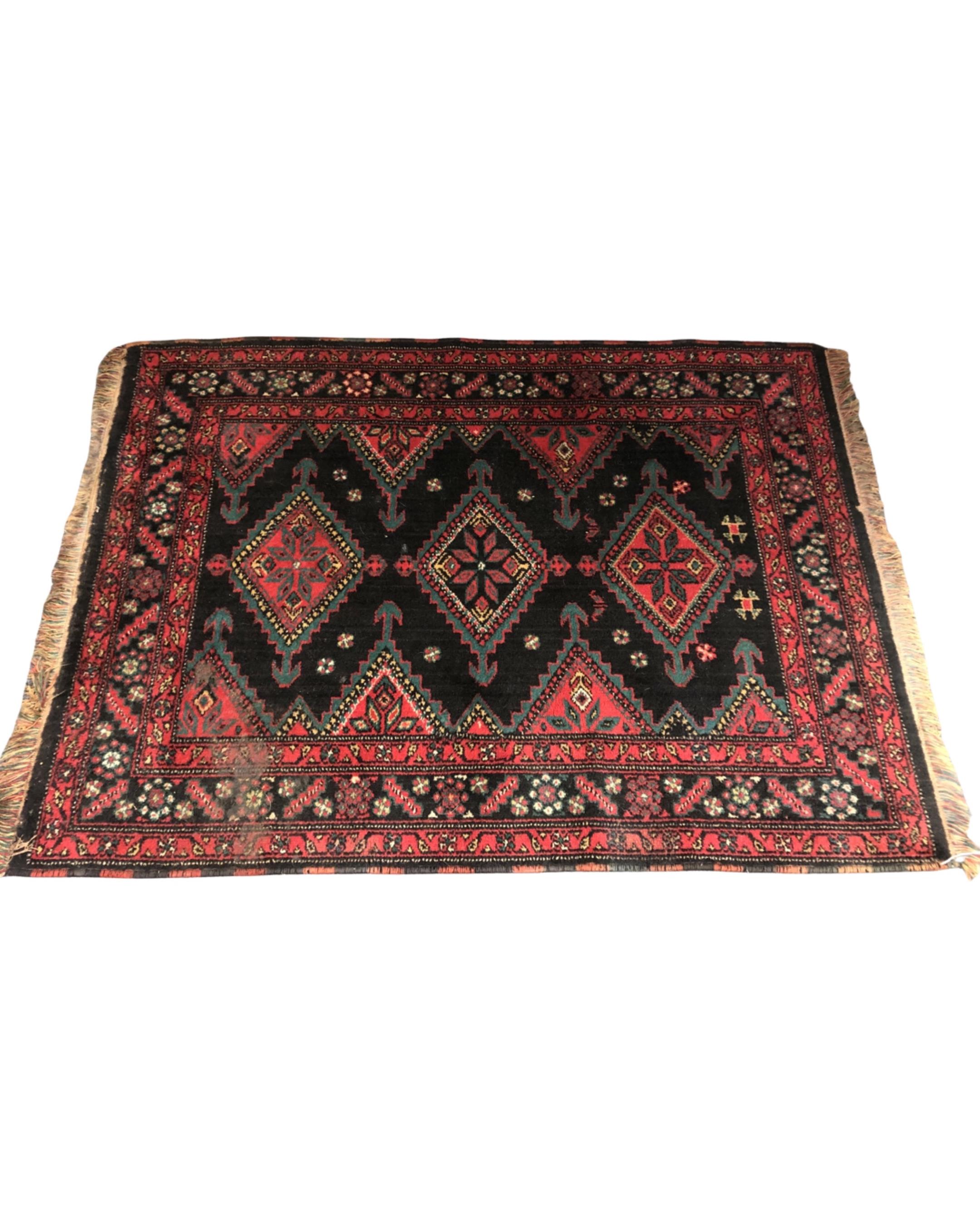 An Iranian rug, 101cm by 135cm.