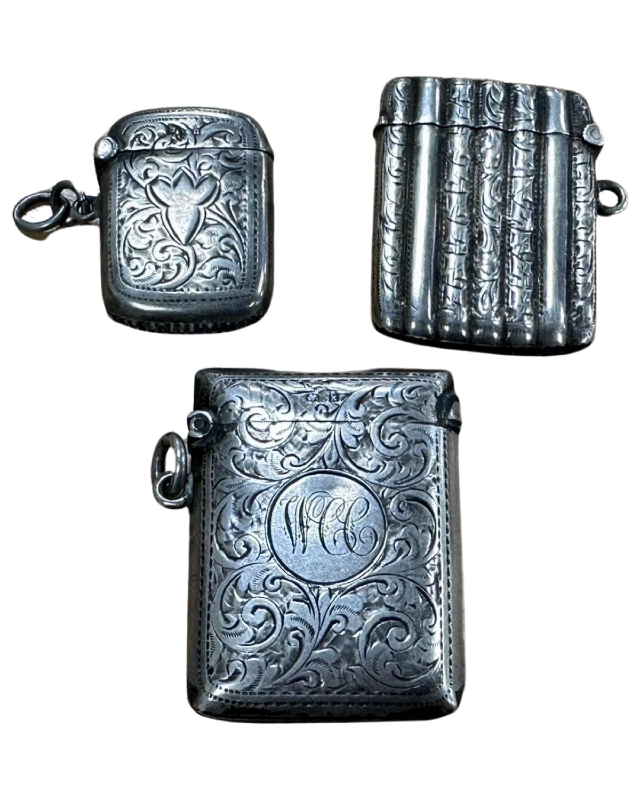 Three antique silver vesta cases.