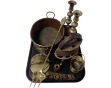 A tray containing antique and later brass and metalware including a trivet, a toasting fork,