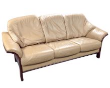 A Danish Hjellegjerde stained beech frame three seater settee upholstered in tan leather.