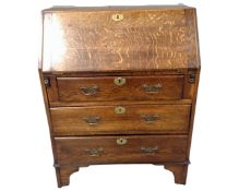 A George III oak writing bureau fitted with three drawers.