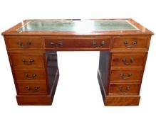 A yew wood twin pedestal writing desk with a green tooled leather inset panel.