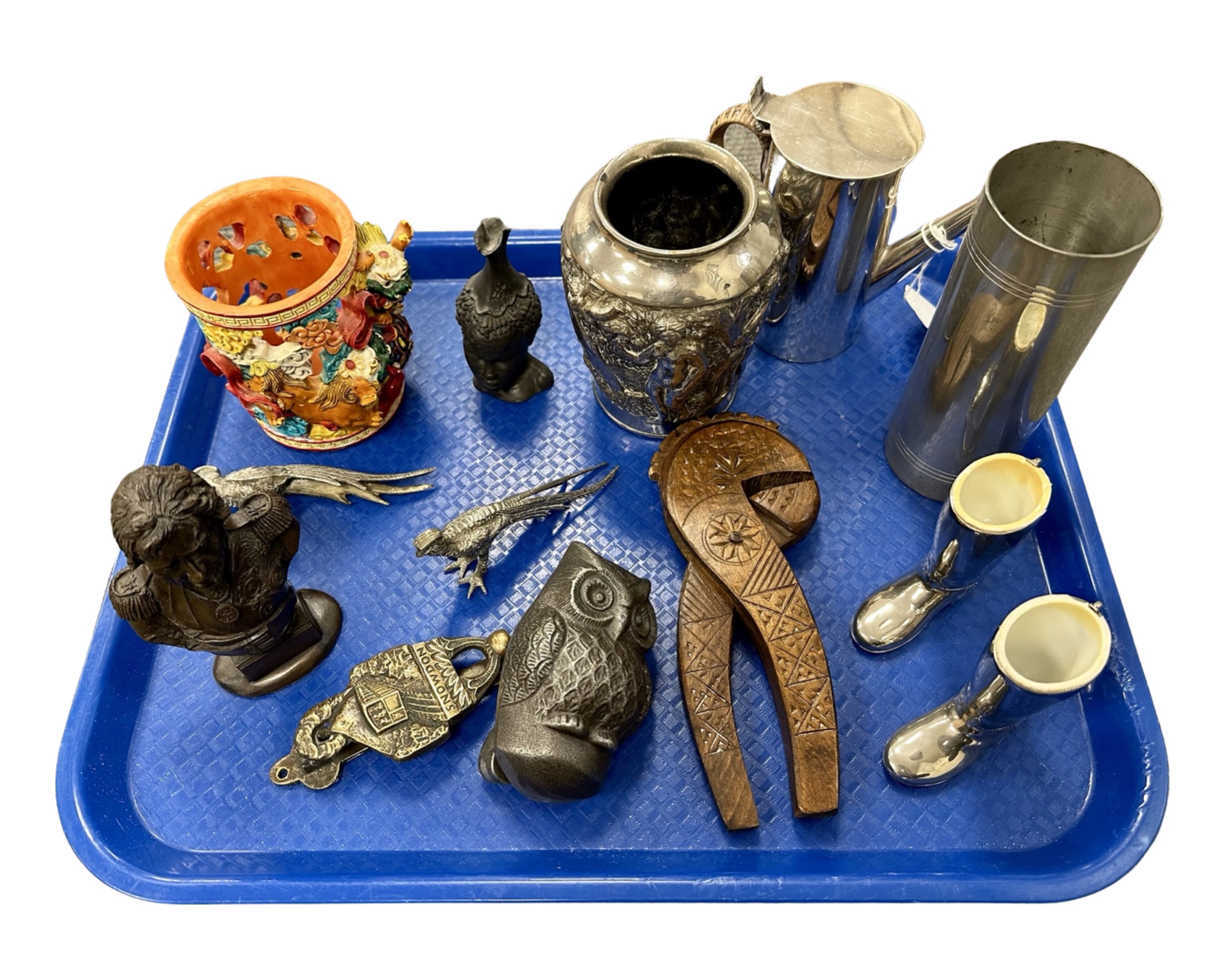 A tray of collectables including carved nut crackers, silver plated items, biblical scene vase,