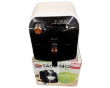 A Tassimo Joy coffee maker (boxed) together with a Tefal fryer.
