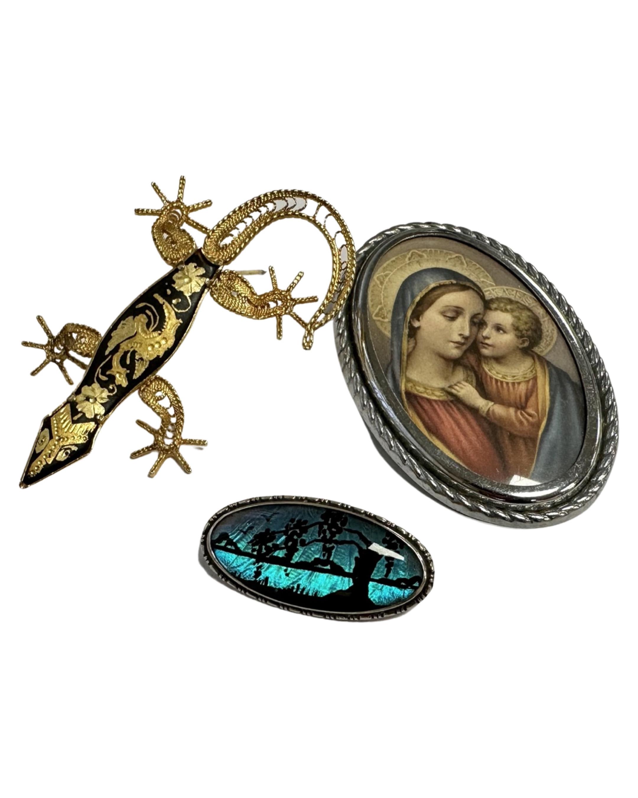 A yellow metal filigree lizard brooch together with Religious brooch and Sterling silver butterfly