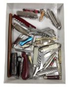 A large quantity of assorted pocket knives together with a Japanese style letter opener.