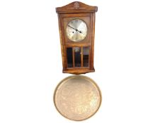 An oak cased 8 day wall clock with silvered dial together with a brass Indian tray.