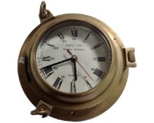 A Rickmer brass cased ship's time porthole wall clock.