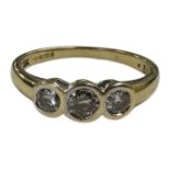 An 18ct gold three stone diamond set ring, the stated total diamond weight 0.50 carat, size N.