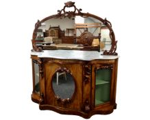 A Victorian carved walnut marble topped chiffoniere with mirrored back.