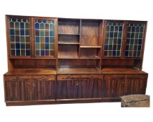 A 20th century Danish rosewood veneered triple section bookcase.
