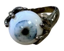 A brass 'eye' ring, size N.