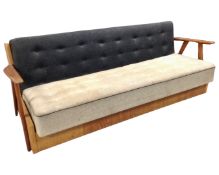 A mid-20th century teak framed bed settee.