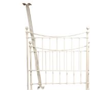 A contemporary white metal 4'6" bed frame.