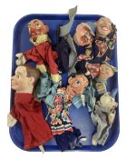 A tray containing seven vintage hand puppets.
