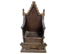 A cast iron money box 'The Imperial Throne', height 21 cm.