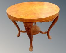 A 20th century circular walnut occasional table.