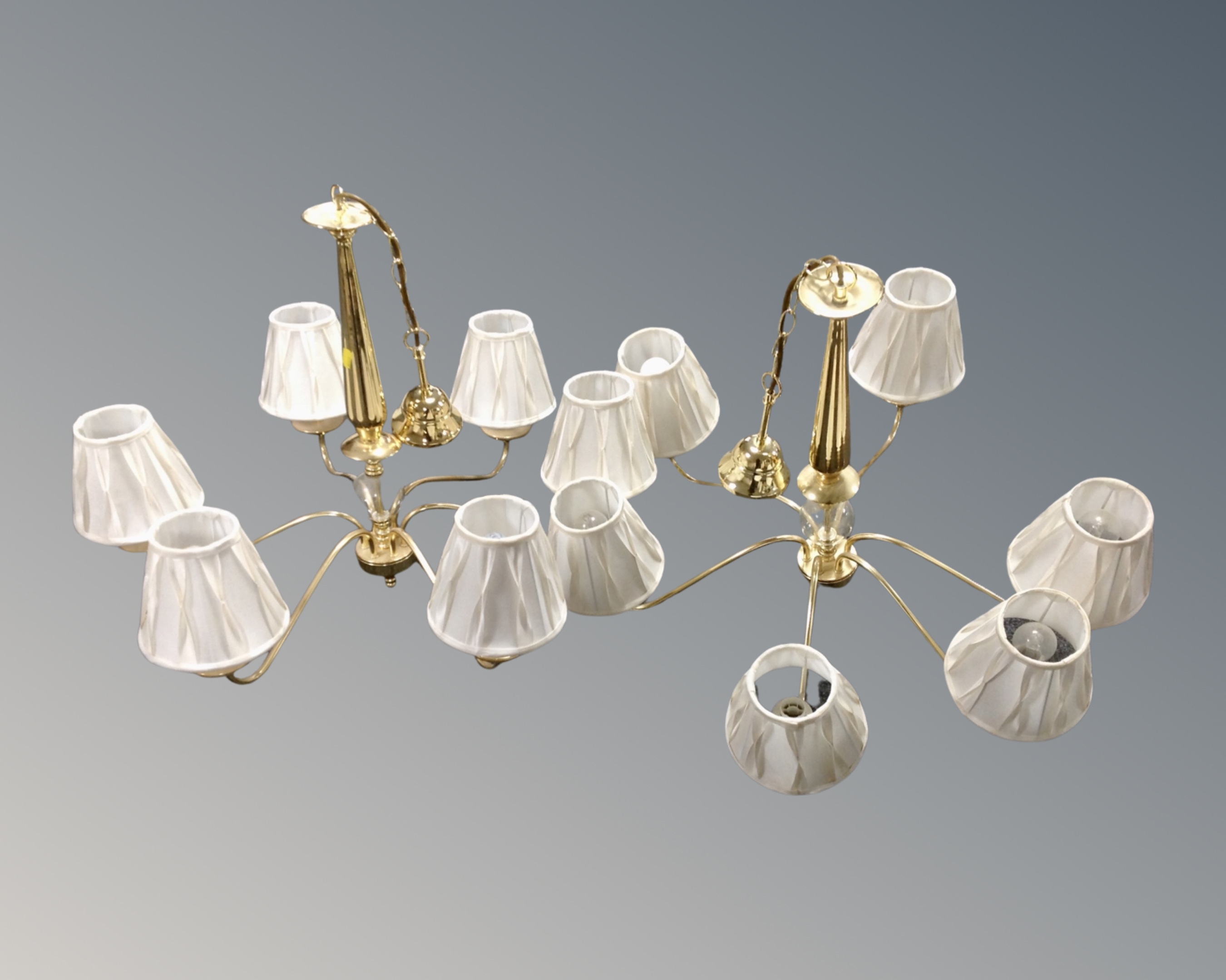 A pair of contemporary brass six way light fittings, with shades.