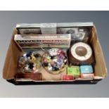 A box containing playing cards, board games, miniature ornaments including glass examples,