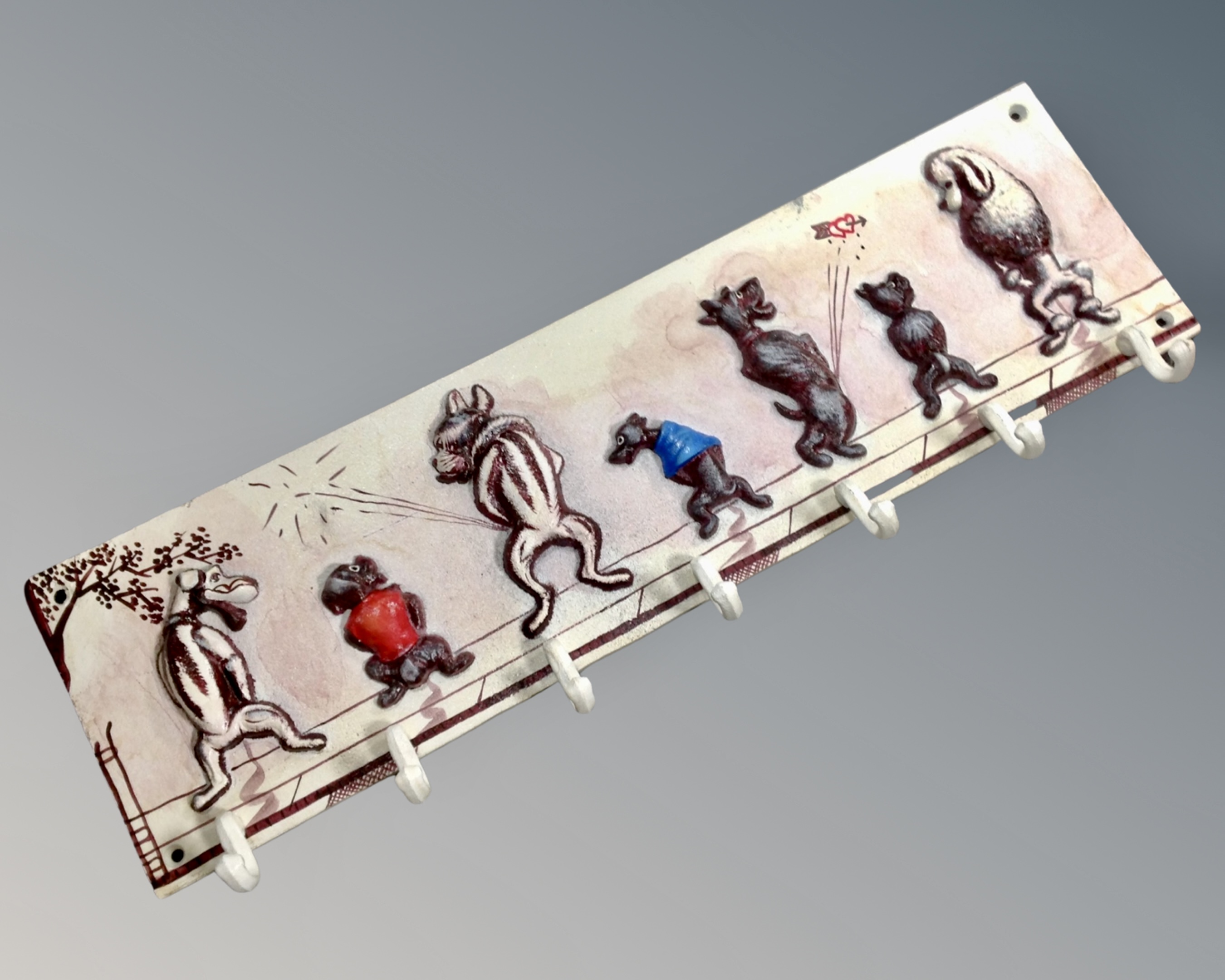 A cast iron dog seven hook coat rack.