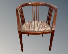 An Edwardian inlaid mahogany open tub chair.