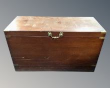 A mahogany brass bound shipping trunk.