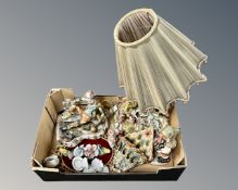 A box containing Italian figurines, a figural table lamp, wall pocket and plaque.