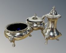 A Georgian style silver three piece cruet set, with lion masks and paw feet.