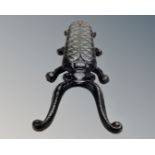 A cast iron scarab boot jack.