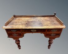 A 19th century mahogany and beech five drawer writing table on raised legs.