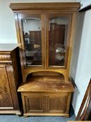 An early 20th century continental inlaid mahogany glazed door bookcase fitted with cupboards and
