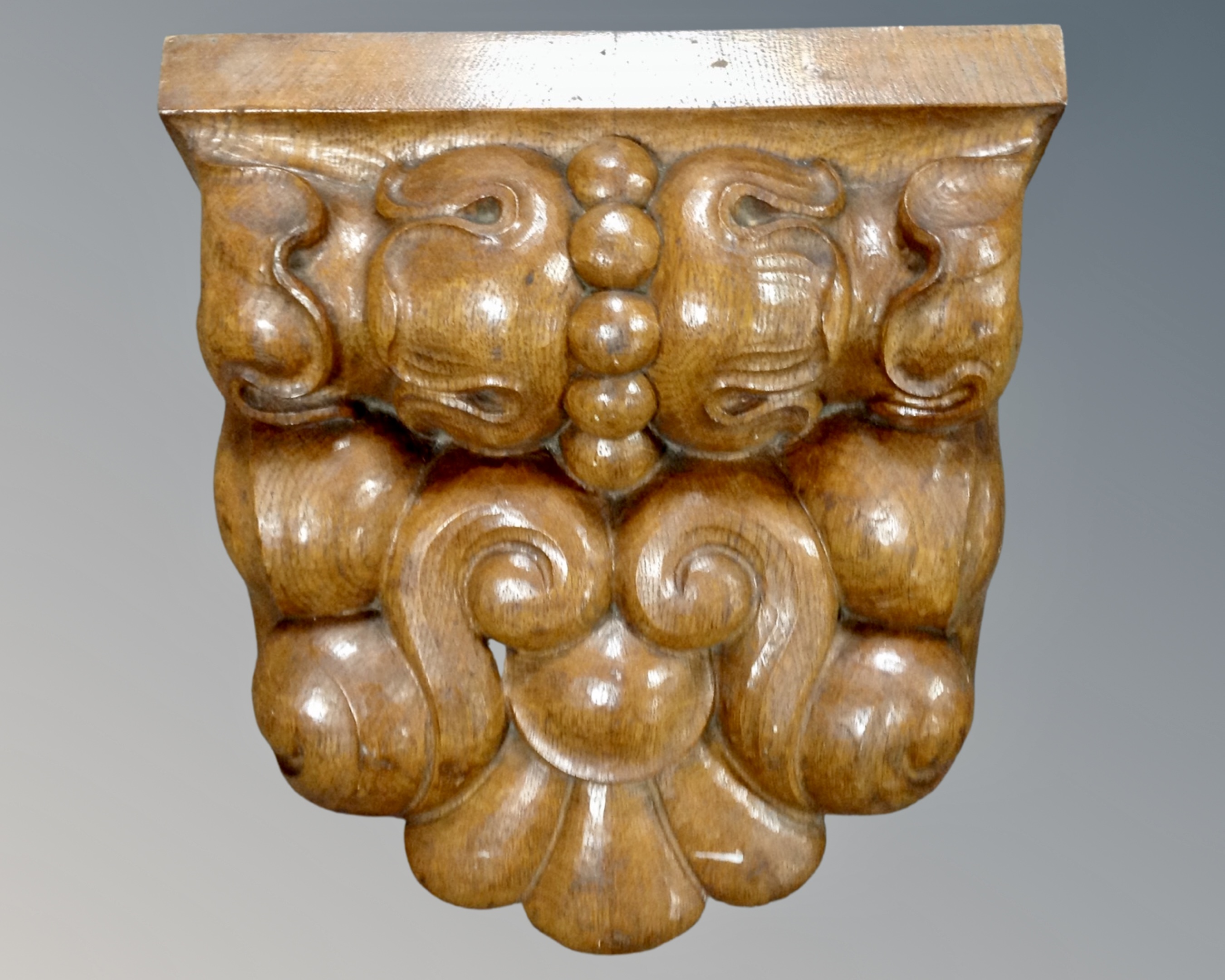 A carved wooden corbel. 36 cm x 35 cm x 19 cm.