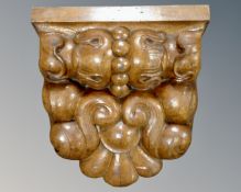 A carved wooden corbel. 36 cm x 35 cm x 19 cm.