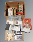 A box containing First Day Covers, stamp books,