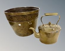 An embossed brass plant pot together with a brass kettle.