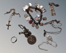 A box containing a collection of silver jewellery including an ingot and pendants on chains,