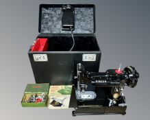 A scarce Singer 222k electric sewing machine in carry case with accessories.